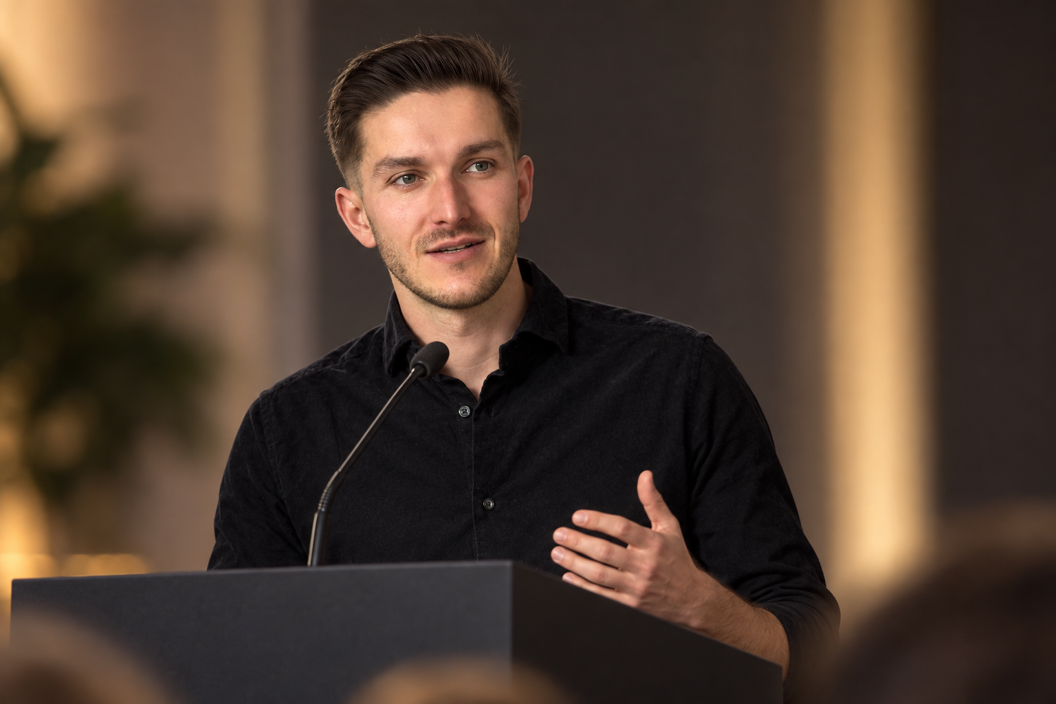 André Wendland speaking at a podium